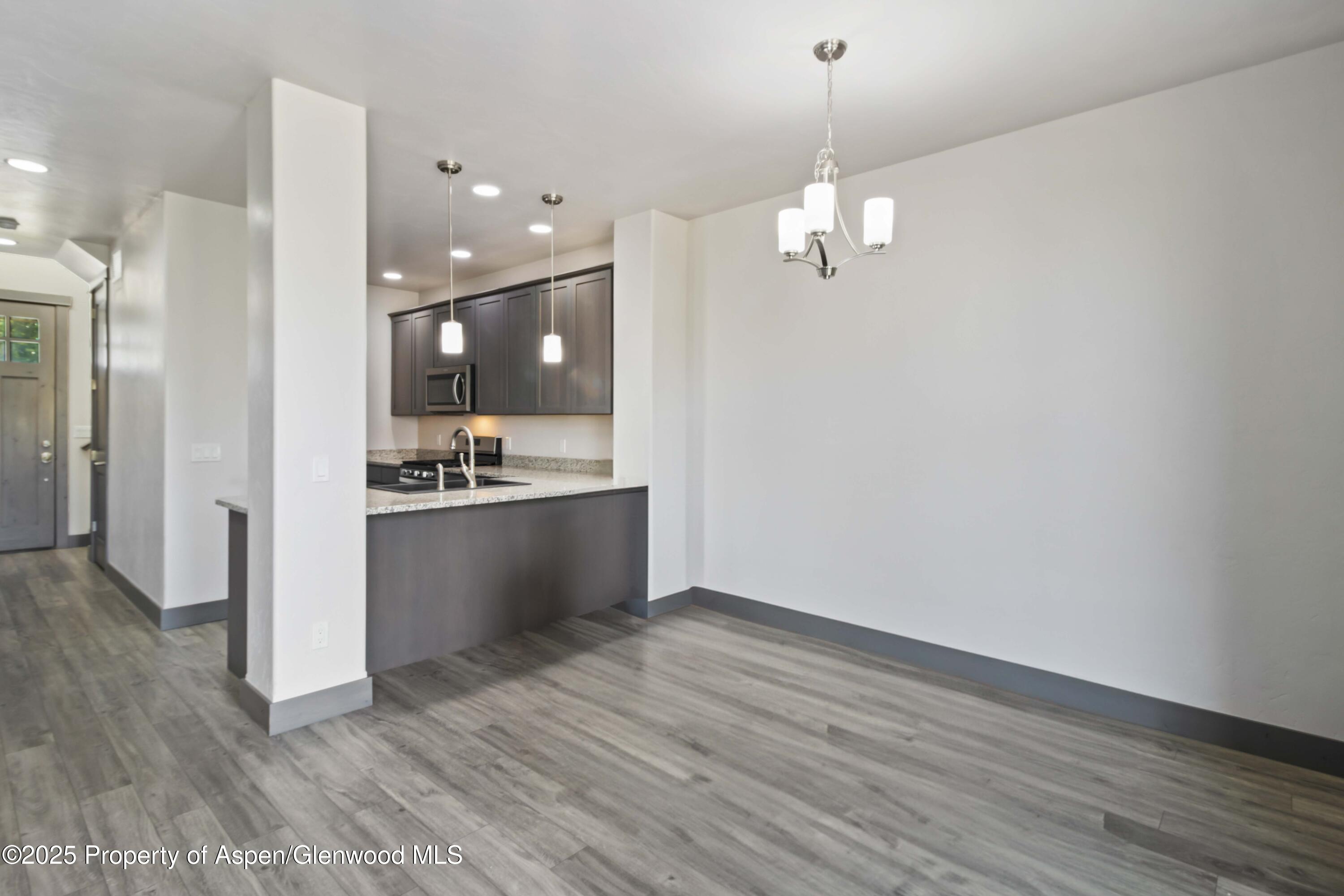 123 Redstone Drive New Castle, CO 81647 - Photo 19 of 34 a view of kitchen with refrigerator and wooden floor
