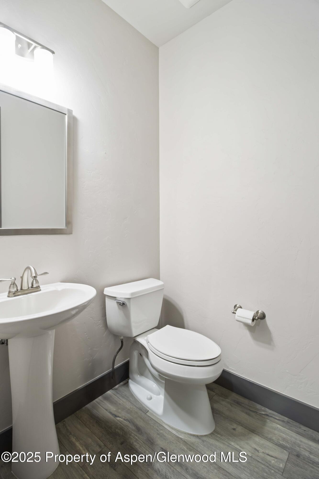 123 Redstone Drive New Castle, CO 81647 - Photo 25 of 34 a white toilet sitting next to a bathroom sink