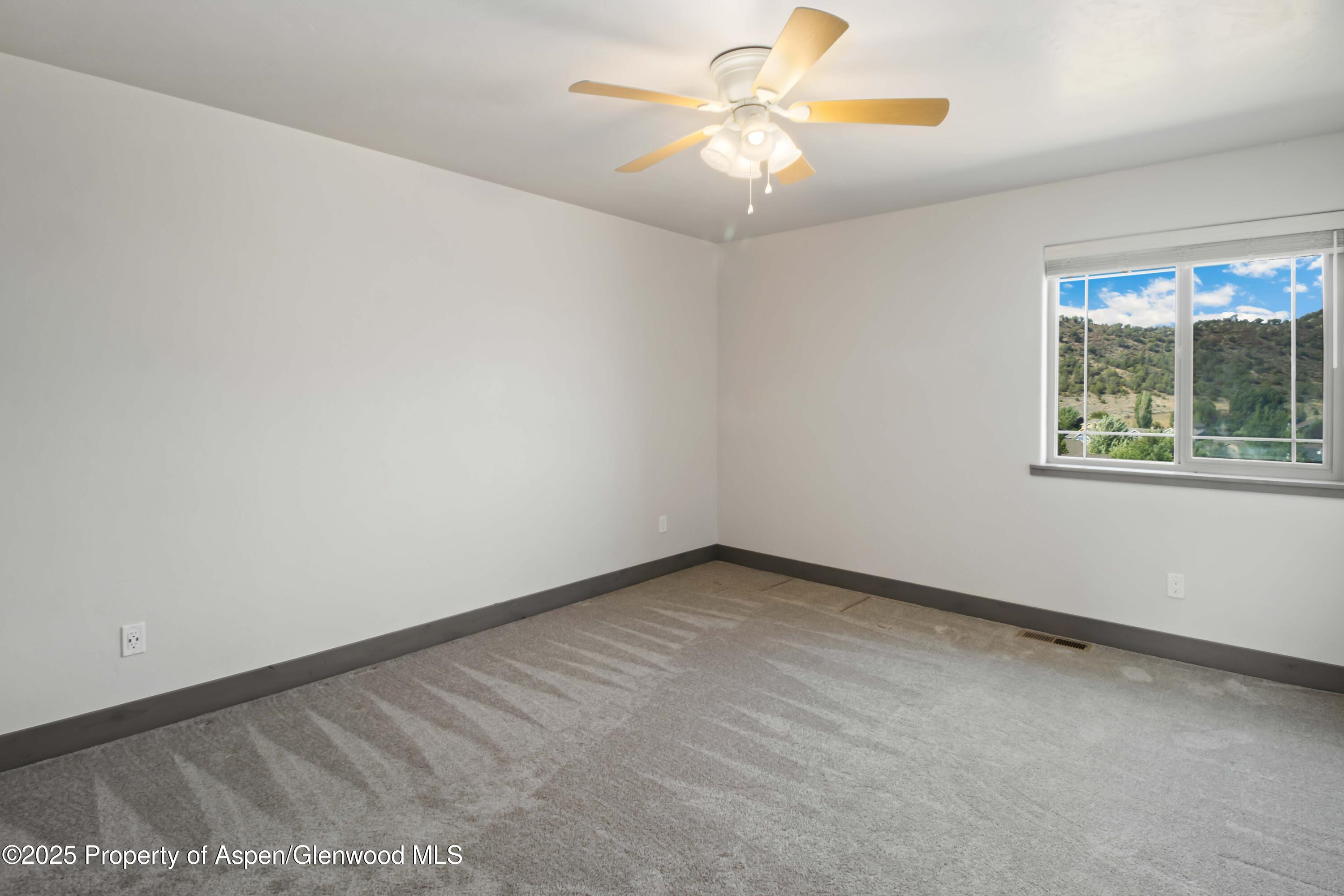 123 Redstone Drive New Castle, CO 81647 - Photo 28 of 34 an empty room with a window and a fan