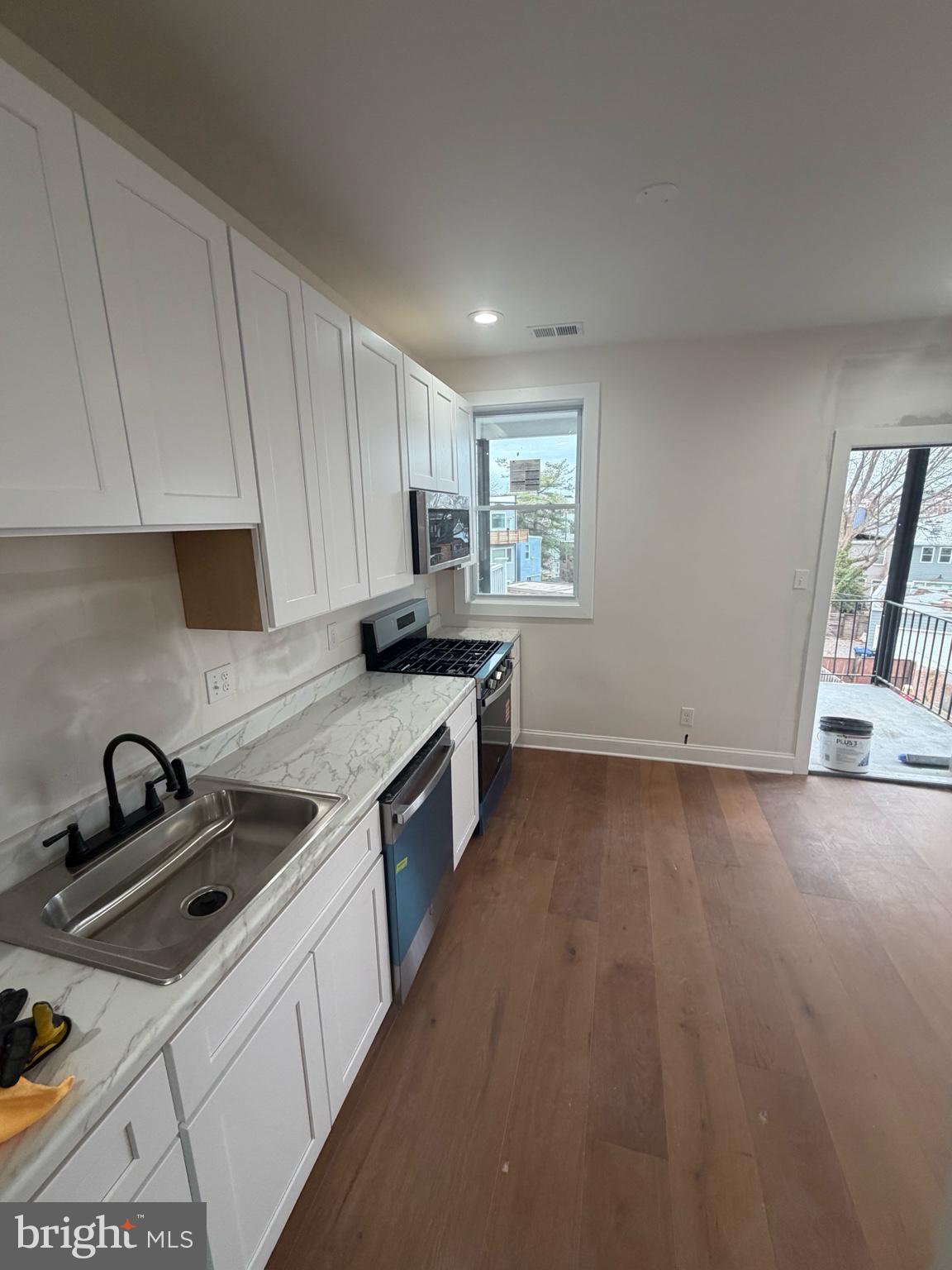 1224 Maryland Avenue Northeast, Unit 3 Washington, DC 20002 - Photo 2 of 12 a kitchen that has a sink and a stove