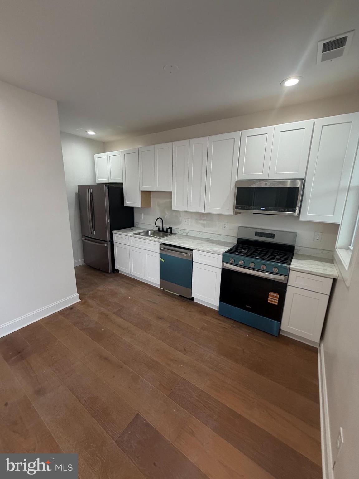 1224 Maryland Avenue Northeast, Unit 3 Washington, DC 20002 - Photo 3 of 12 a kitchen with a refrigerator and a stove top oven