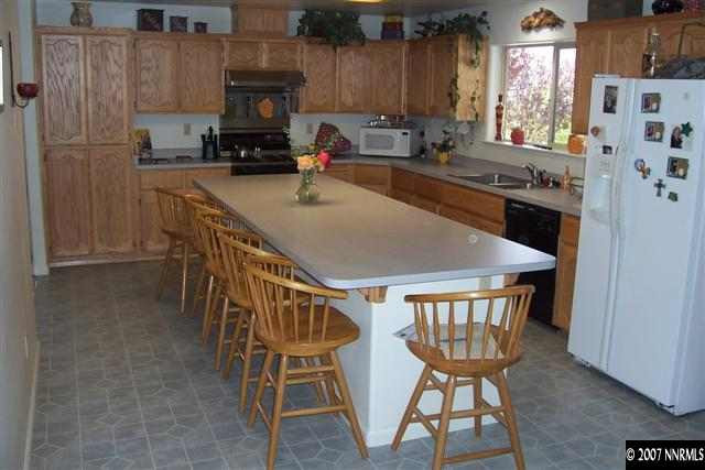 3200 Bacon Rind Road Reno, NV 89510 - Photo 3 of 9 a kitchen with stainless steel appliances granite countertop a kitchen island a table and chairs in it