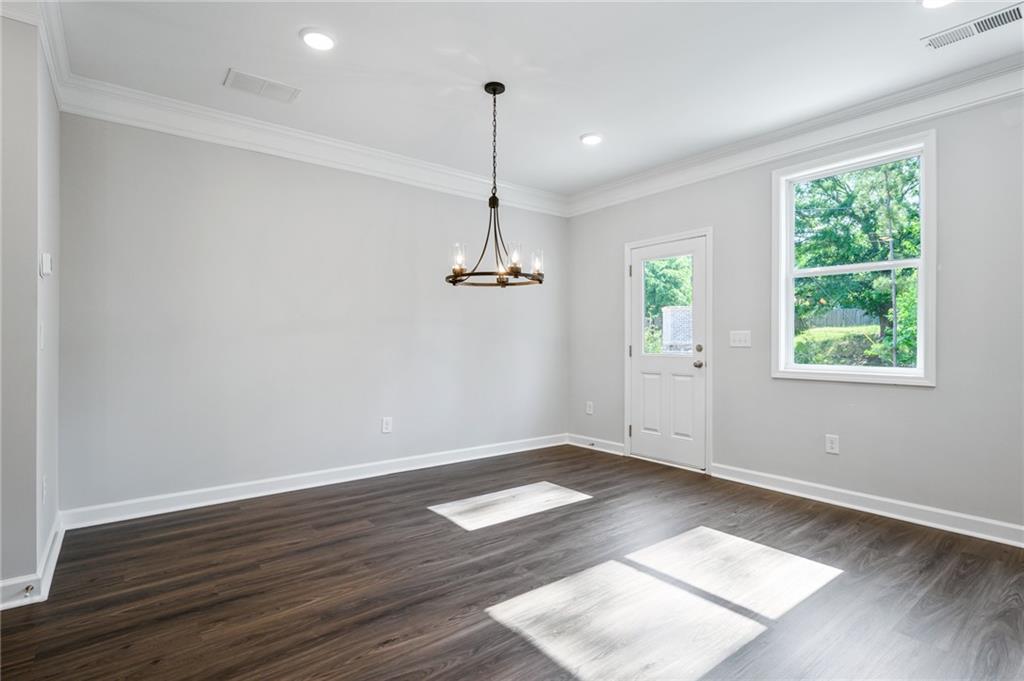 3744 Silvery Way Powder Springs, GA 30127 - Photo 12 of 26 a view of an empty room with wooden floor and a window