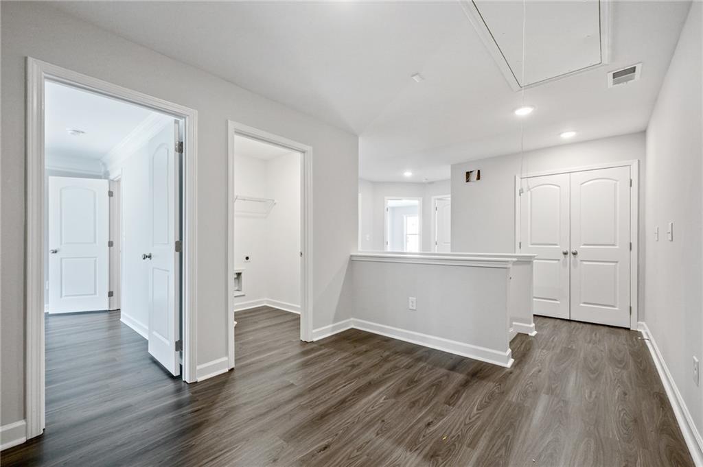 3744 Silvery Way Powder Springs, GA 30127 - Photo 14 of 26 a view of an empty room with wooden floor