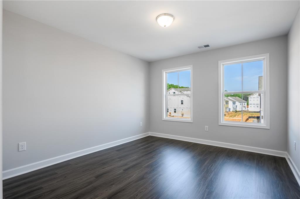 3744 Silvery Way Powder Springs, GA 30127 - Photo 15 of 26 an empty room with wooden floor and window