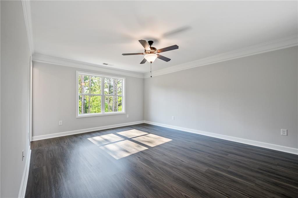 3744 Silvery Way Powder Springs, GA 30127 - Photo 19 of 26 an empty room with wooden floor and windows