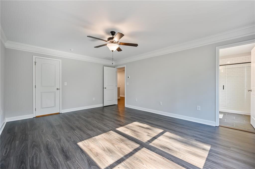 3744 Silvery Way Powder Springs, GA 30127 - Photo 20 of 26 an empty room with wooden floor and windows