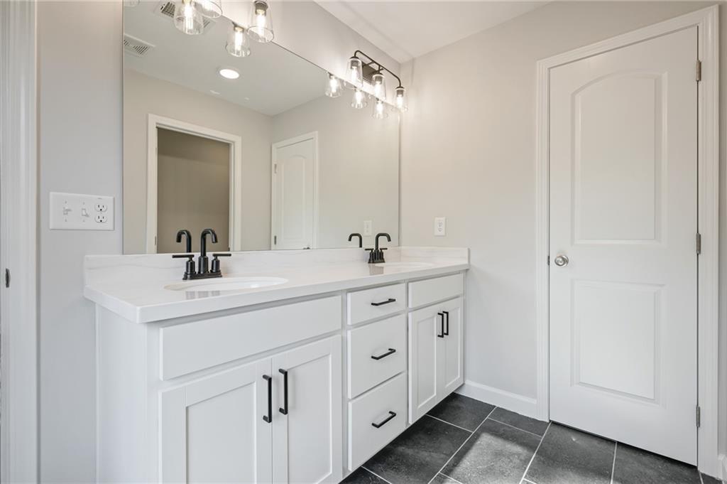 3744 Silvery Way Powder Springs, GA 30127 - Photo 23 of 26 a spacious bathroom with a double vanity sink double and mirror