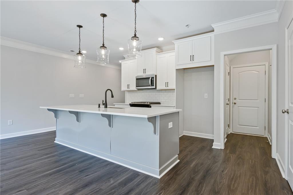 3744 Silvery Way Powder Springs, GA 30127 - Photo 8 of 26 a kitchen with white cabinets and sink