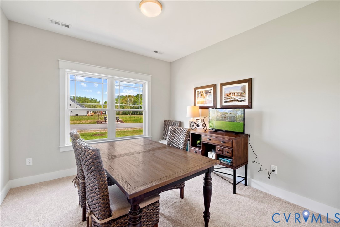 16851 Sheppards Fold Way Beaverdam, VA 23015 - Photo 15 of 33 a view of a dining room with furniture a rug and wooden floor