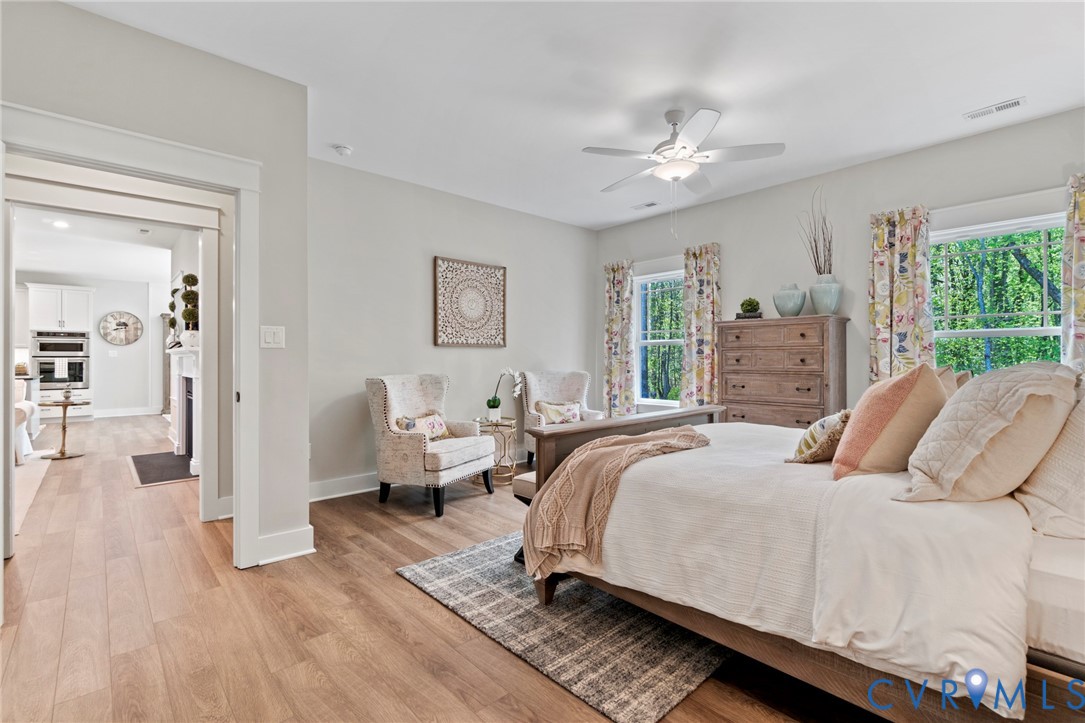 16851 Sheppards Fold Way Beaverdam, VA 23015 - Photo 21 of 33 a bedroom with a large bed a chandelier and windows