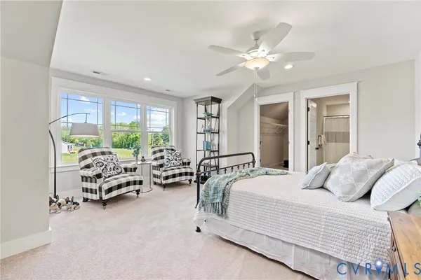 a bedroom with furniture and large windows