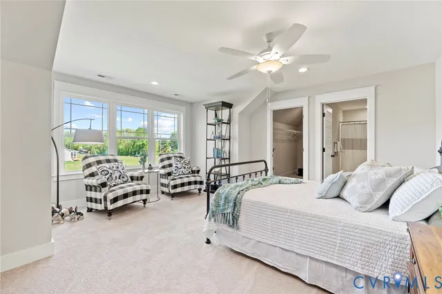 a bedroom with furniture and large windows