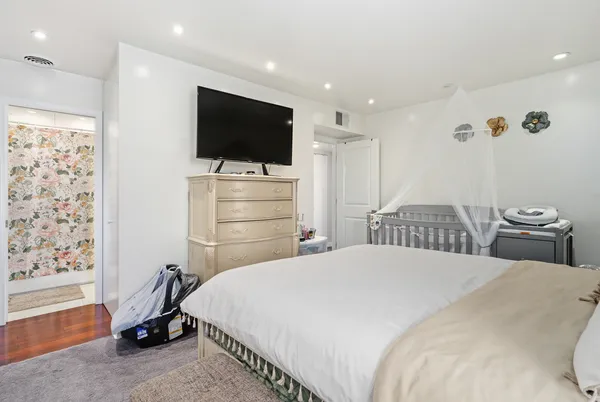 a bedroom with a bed and a flat screen tv