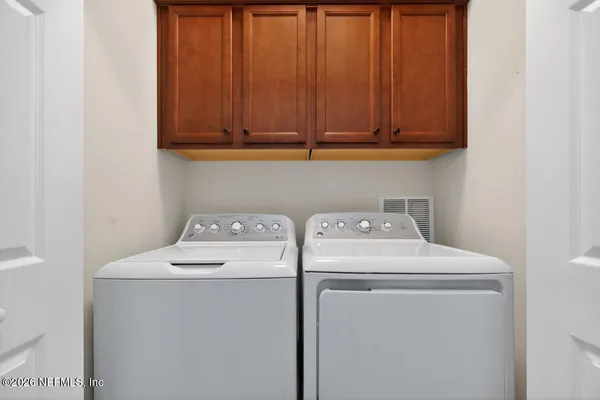 a view of a house with a yard and tree s