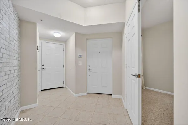 an empty room with ceiling fan and window