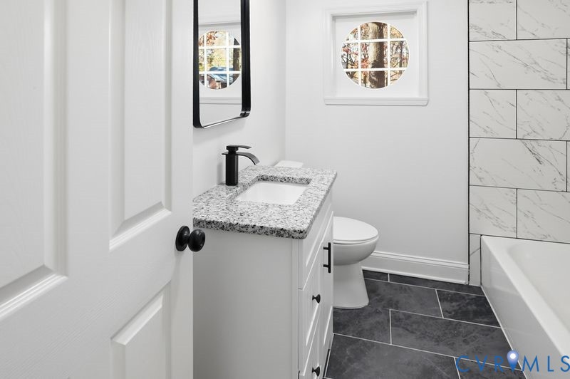 2913 Rolyart Road Petersburg, VA 23805 - Photo 22 of 31 Bathroom with vanity, dark tile patterned flooring
