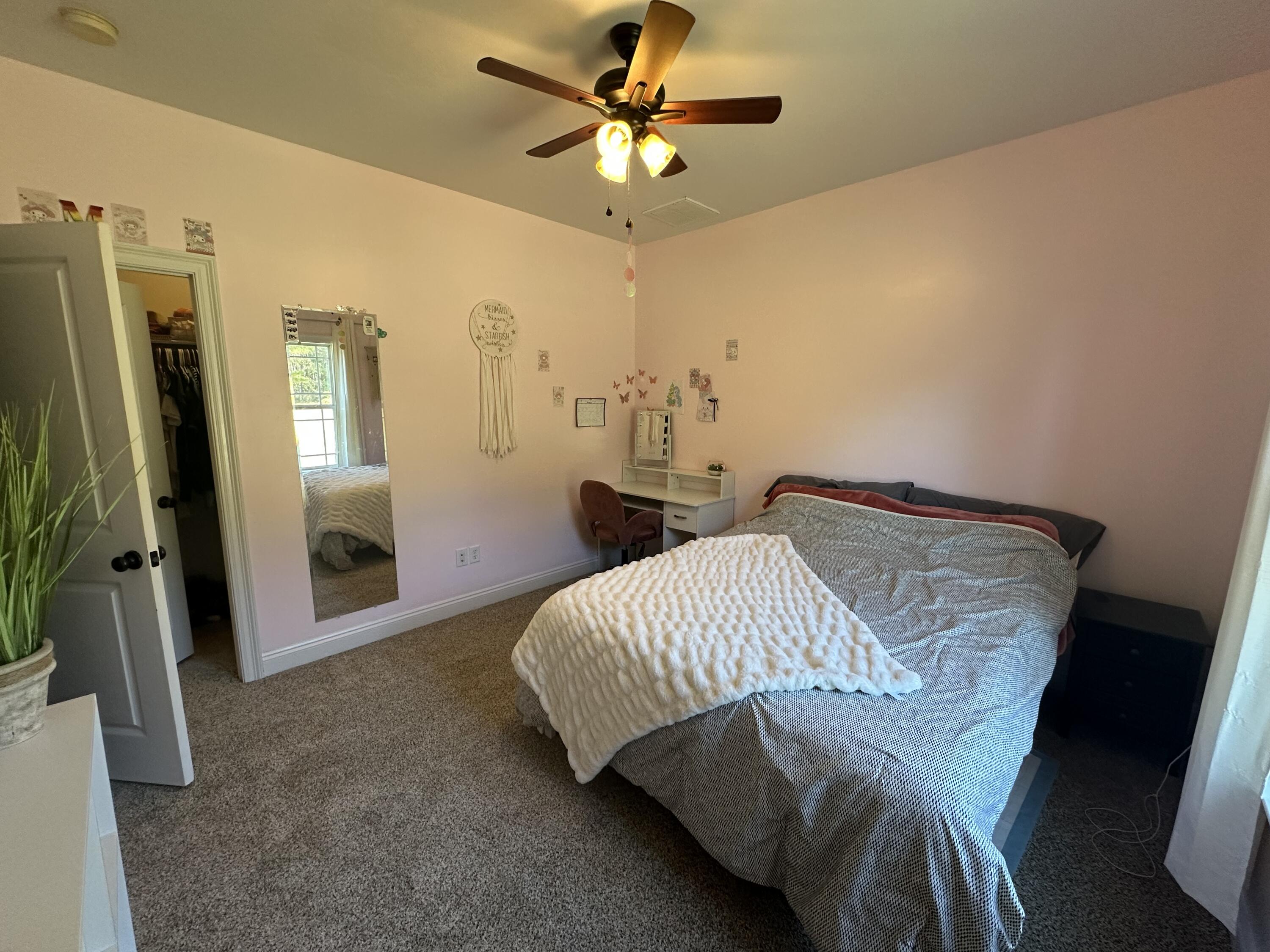 7935 Peacock Road Baker, FL 32531 - Photo 14 of 20 a bedroom with a bed and a chandelier