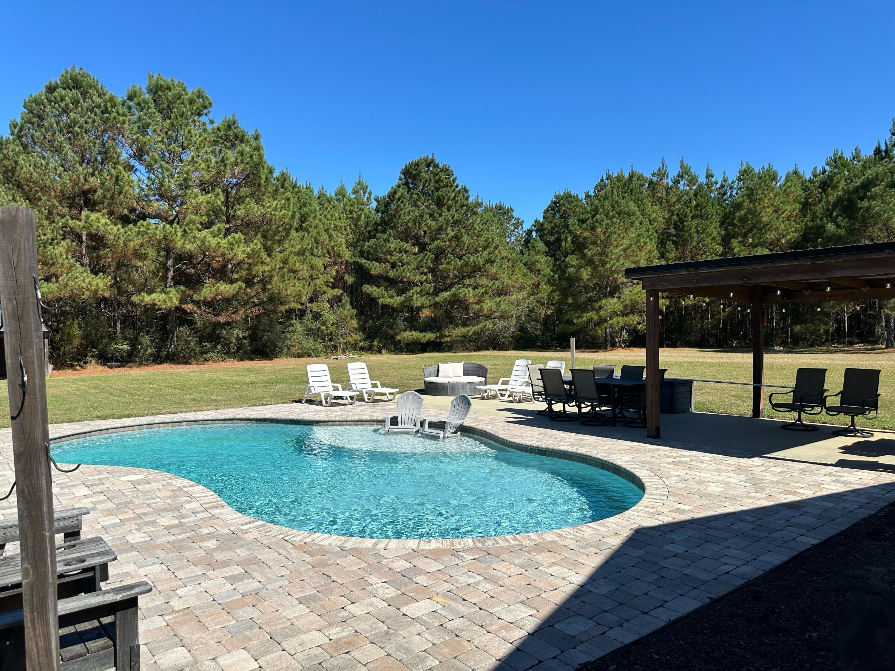 7935 Peacock Road Baker, FL 32531 - Photo 18 of 20 a view of a swimming pool with an outdoor seating