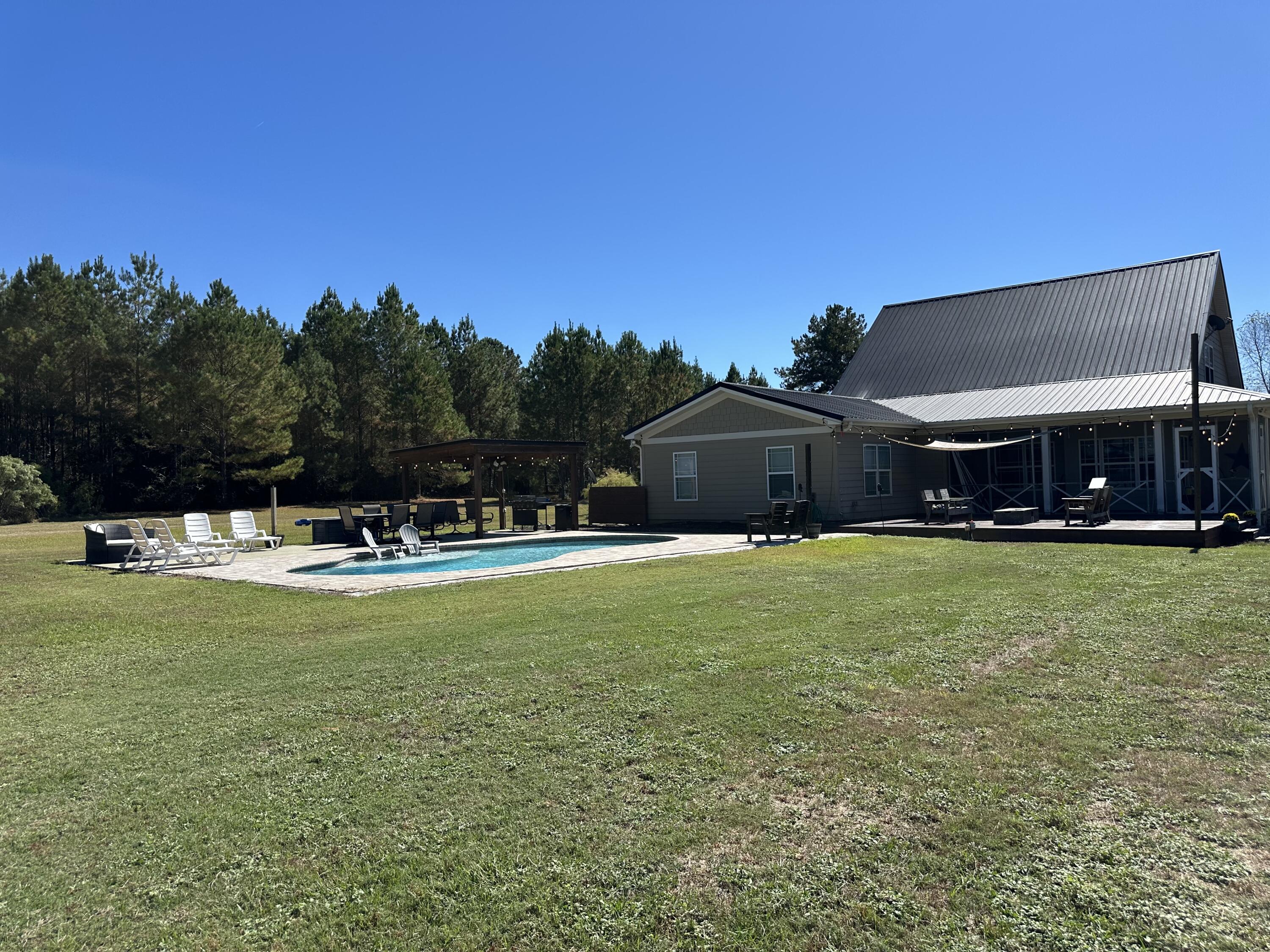 7935 Peacock Road Baker, FL 32531 - Photo 19 of 20 a view of a house with a swimming pool