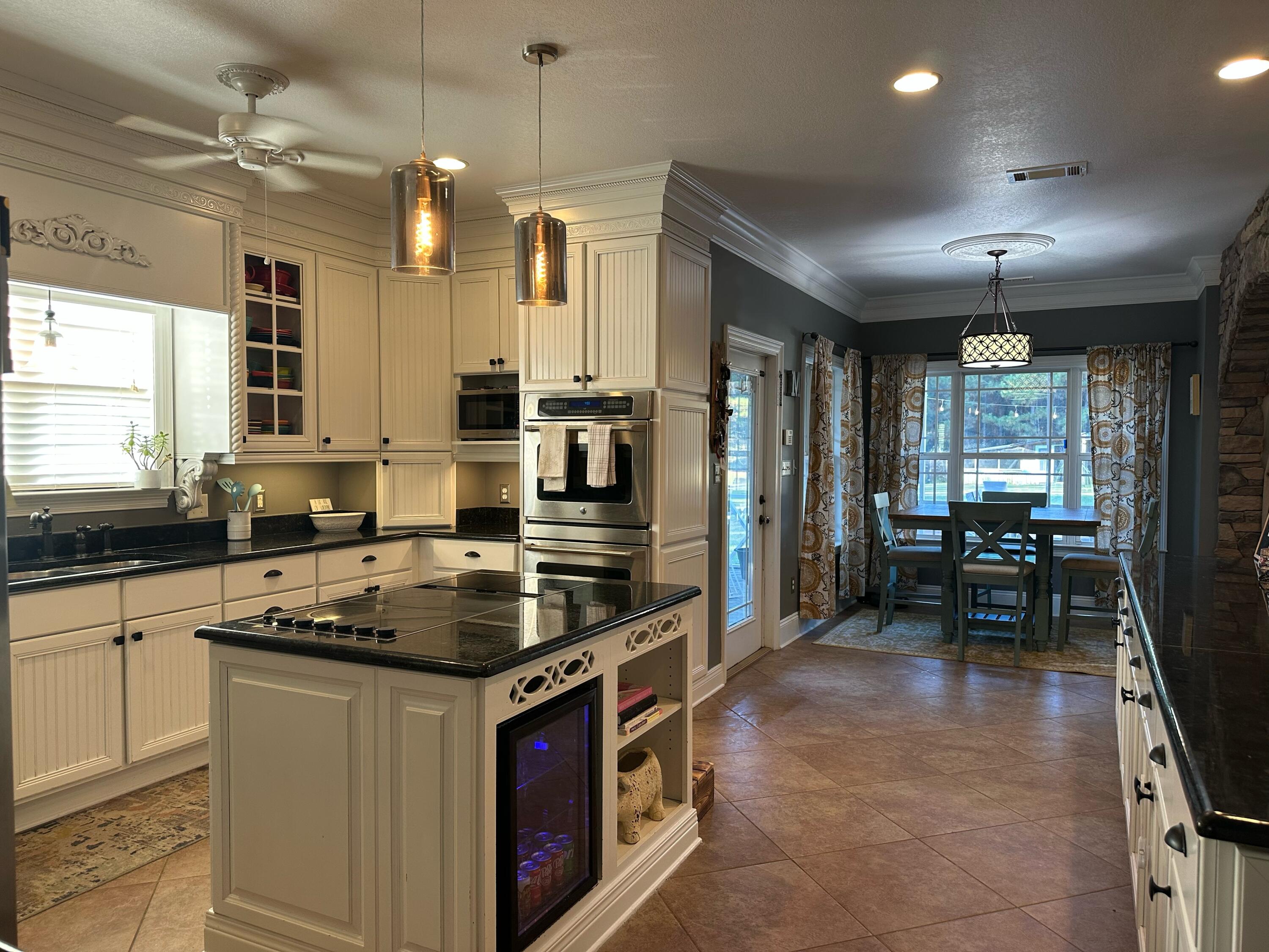 7935 Peacock Road Baker, FL 32531 - Photo 3 of 20 a kitchen with stainless steel appliances granite countertop a stove and a sink