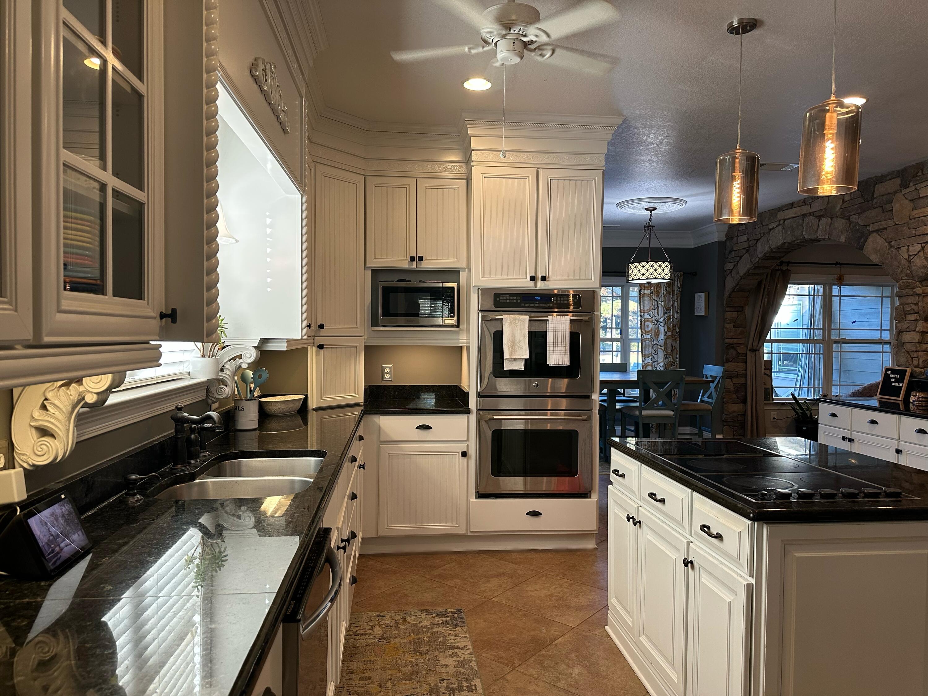 7935 Peacock Road Baker, FL 32531 - Photo 4 of 20 a kitchen with a sink stove and refrigerator
