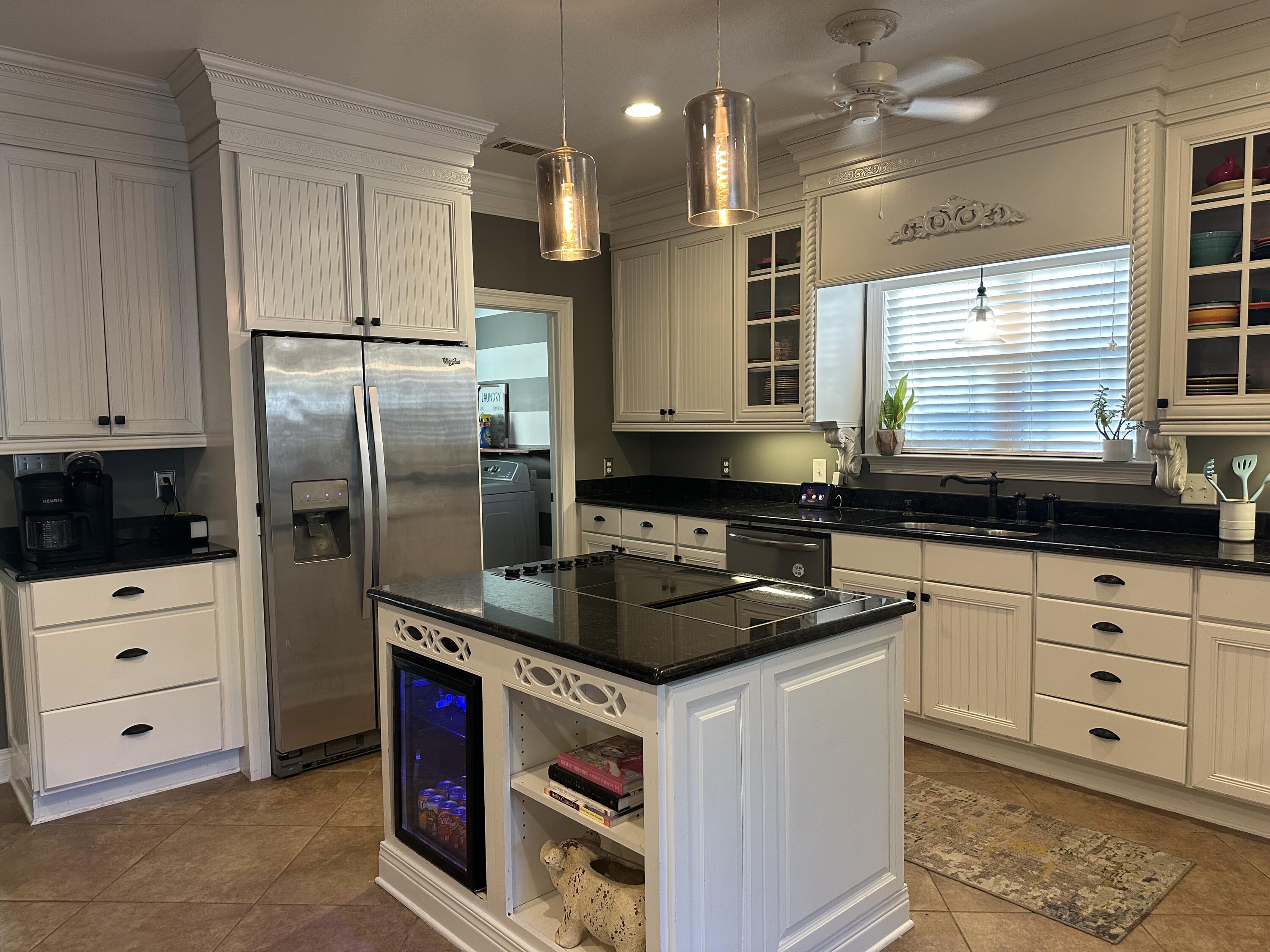 7935 Peacock Road Baker, FL 32531 - Photo 5 of 20 a kitchen with a refrigerator stove and sink