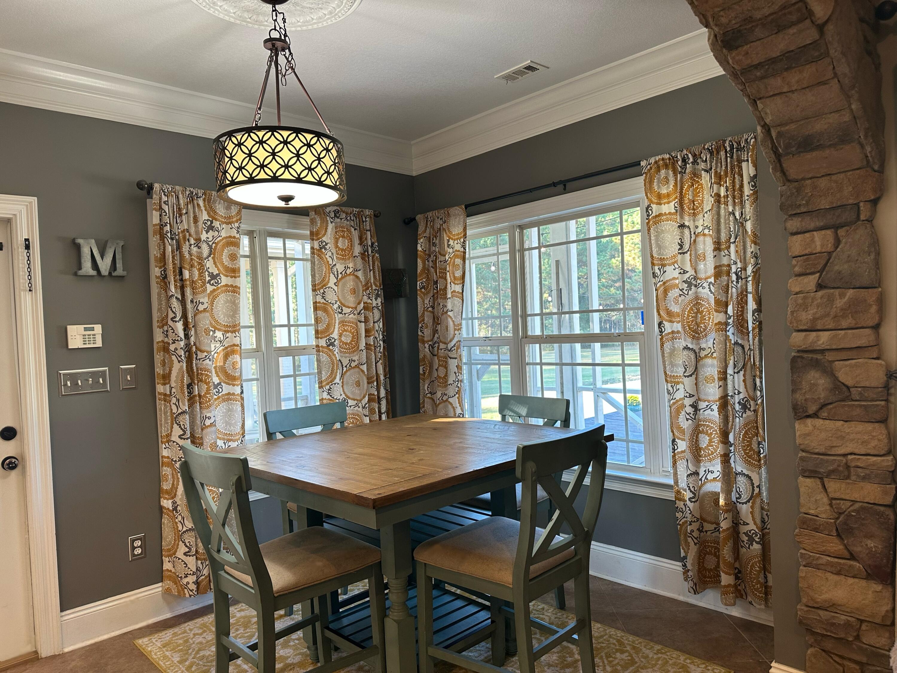 7935 Peacock Road Baker, FL 32531 - Photo 6 of 20 a view of a dining room with furniture window and wooden floor