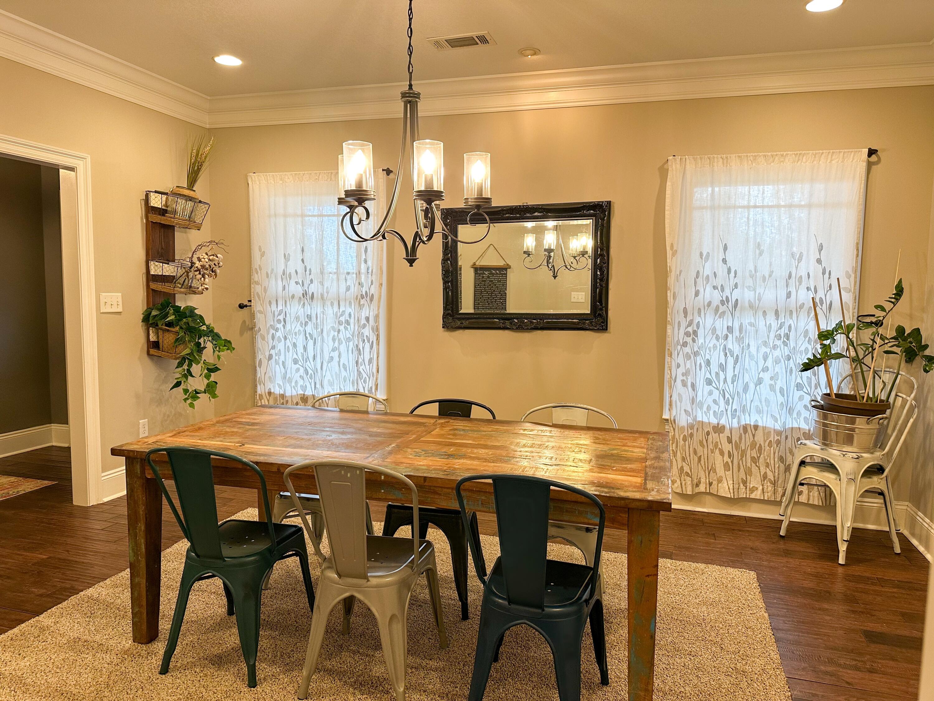 7935 Peacock Road Baker, FL 32531 - Photo 7 of 20 a view of a dining room with furniture and wooden floor