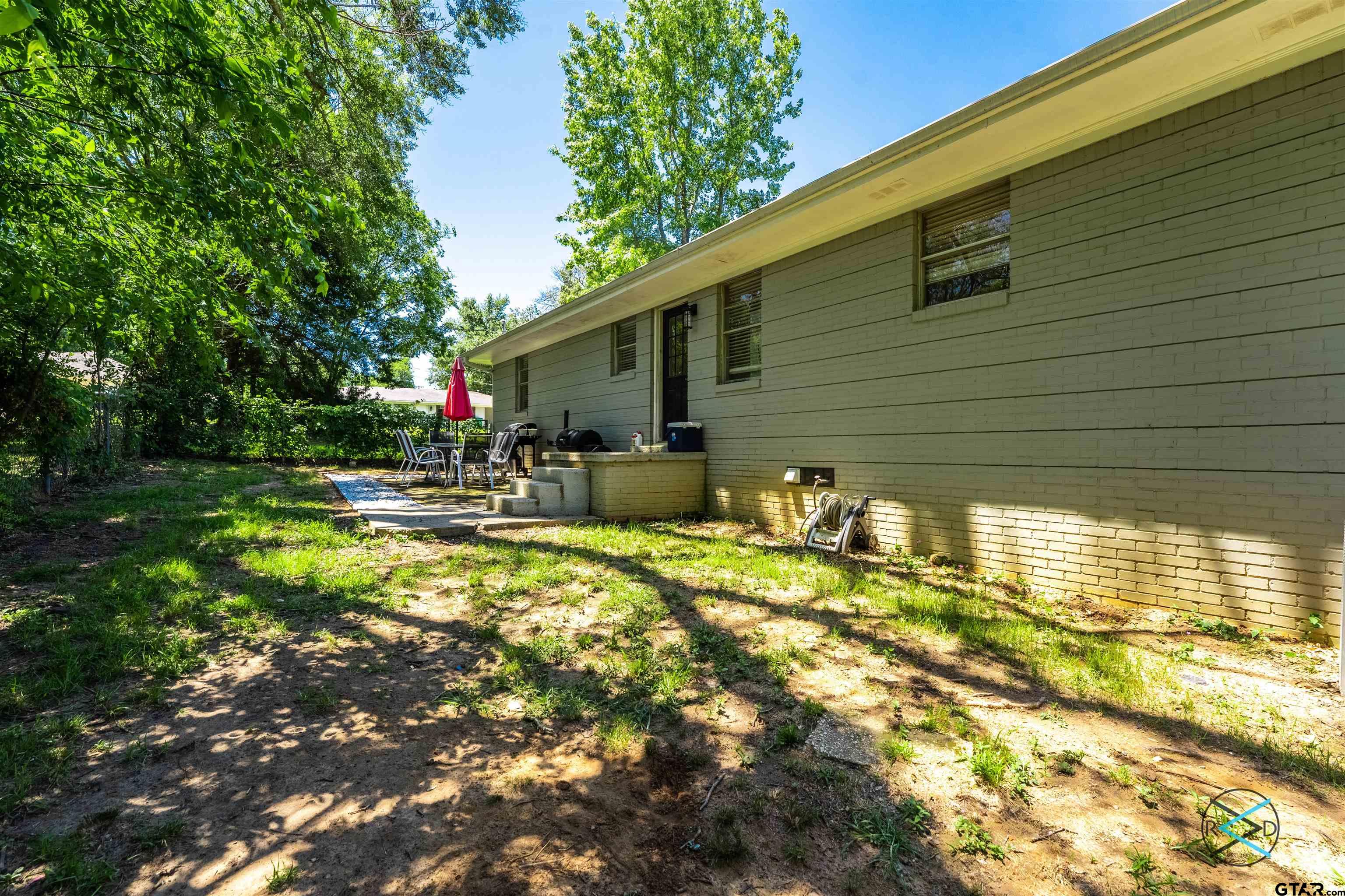 1506 Bassett Road Palestine, TX 75803 - Photo 14 of 18 a backyard of a house with barbeque oven table and chairs