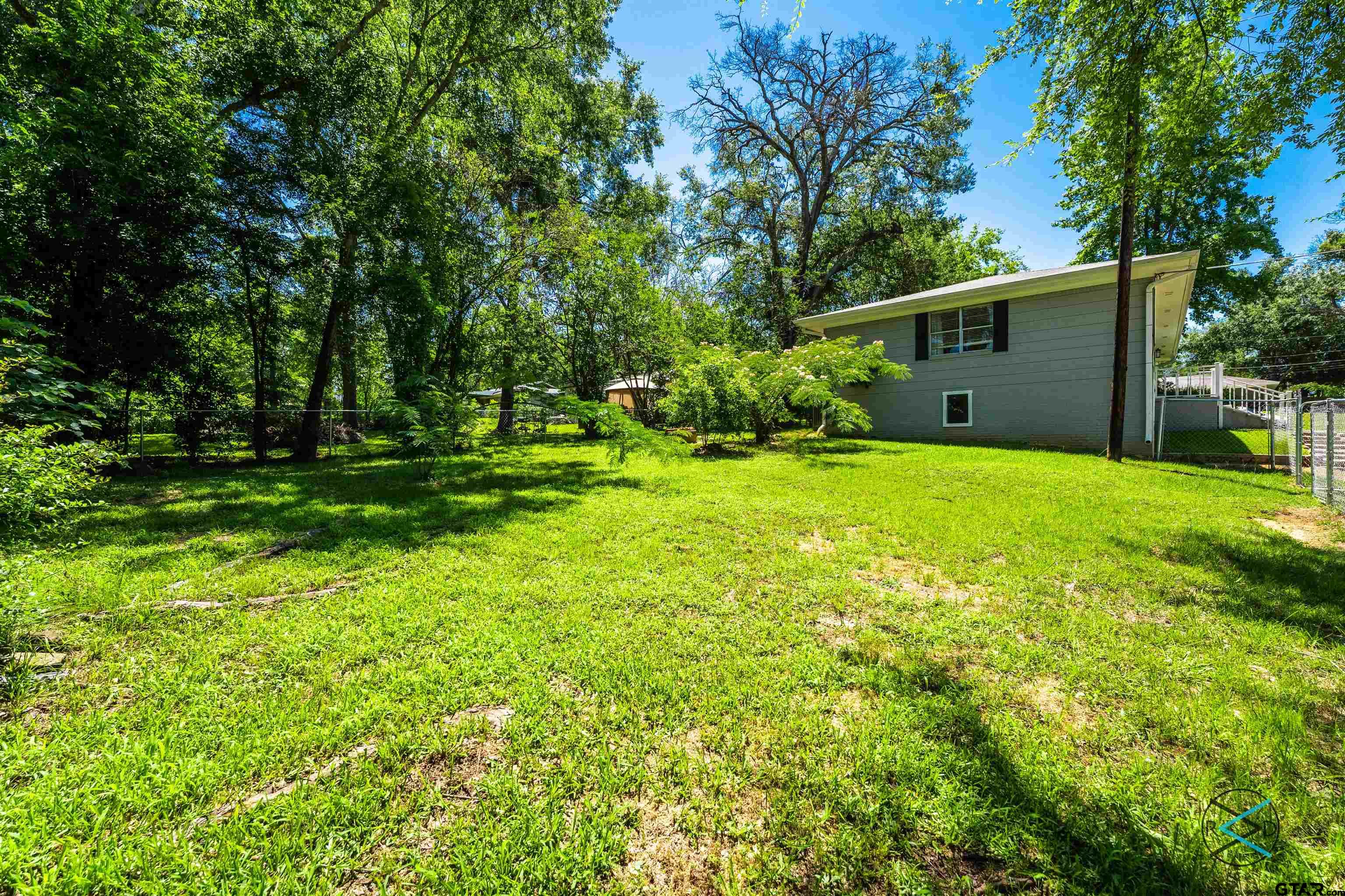 1506 Bassett Road Palestine, TX 75803 - Photo 15 of 18 a view of a backyard with large trees