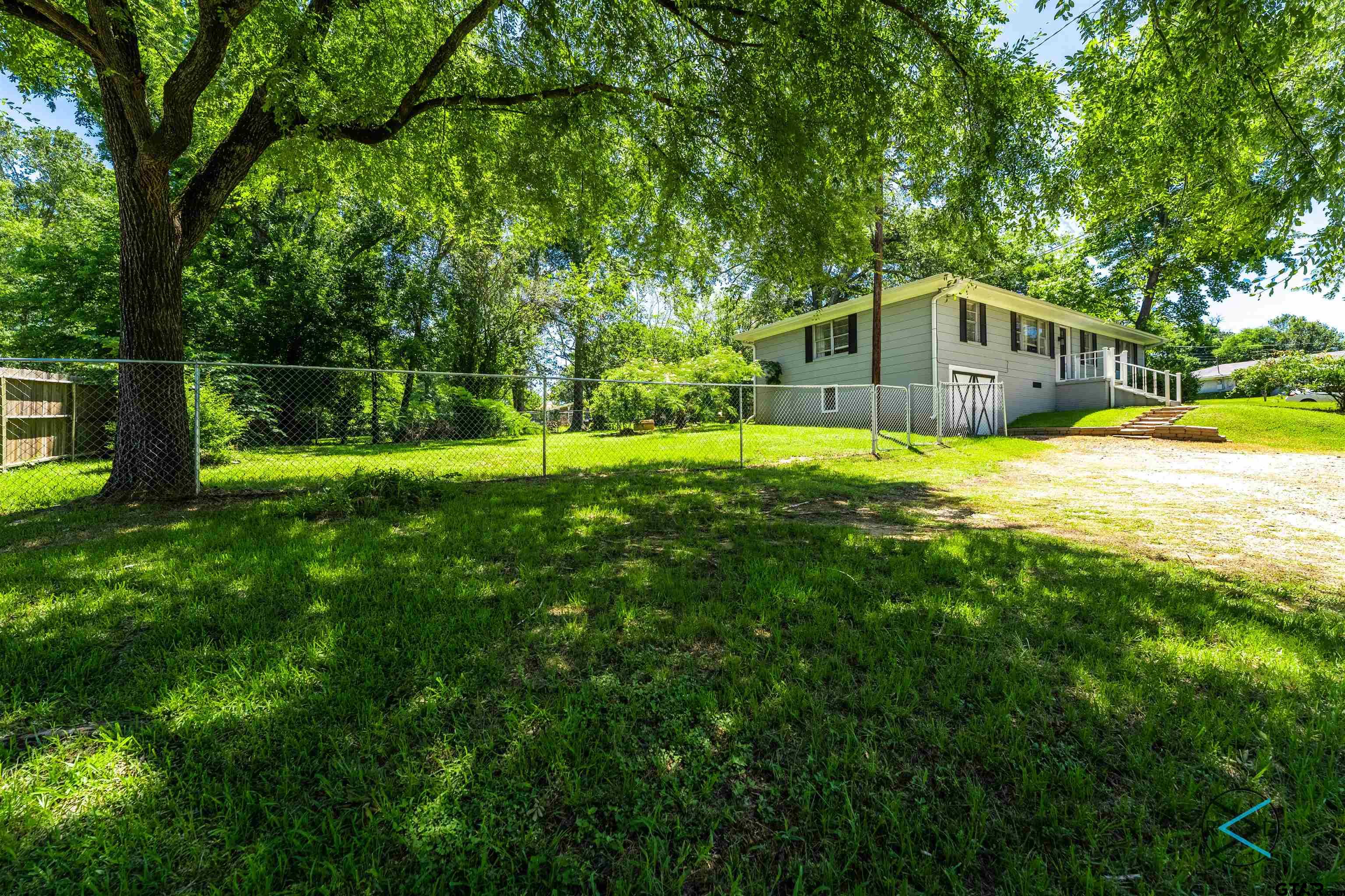 1506 Bassett Road Palestine, TX 75803 - Photo 16 of 18 a house with a big yard and large trees