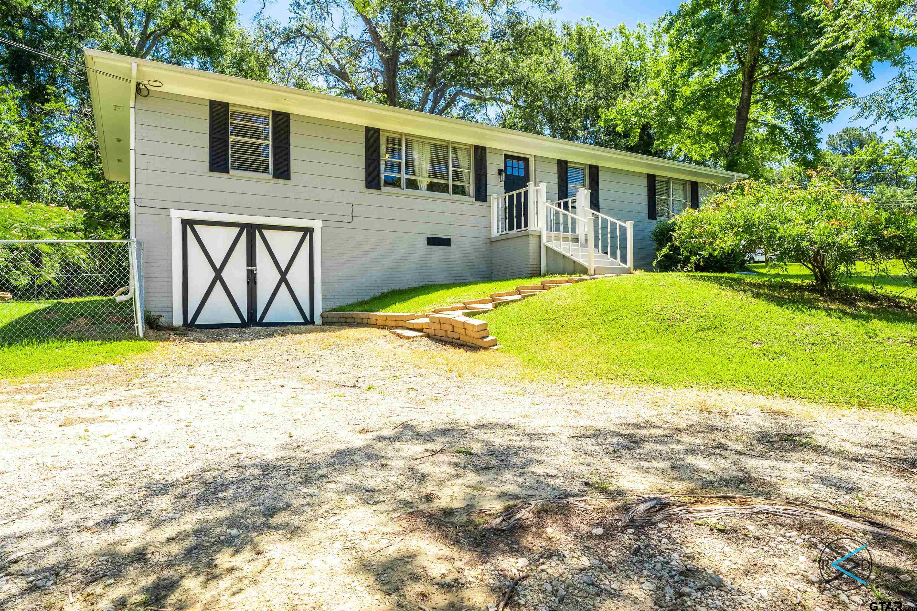1506 Bassett Road Palestine, TX 75803 - Photo 2 of 18 a front view of a house with garden
