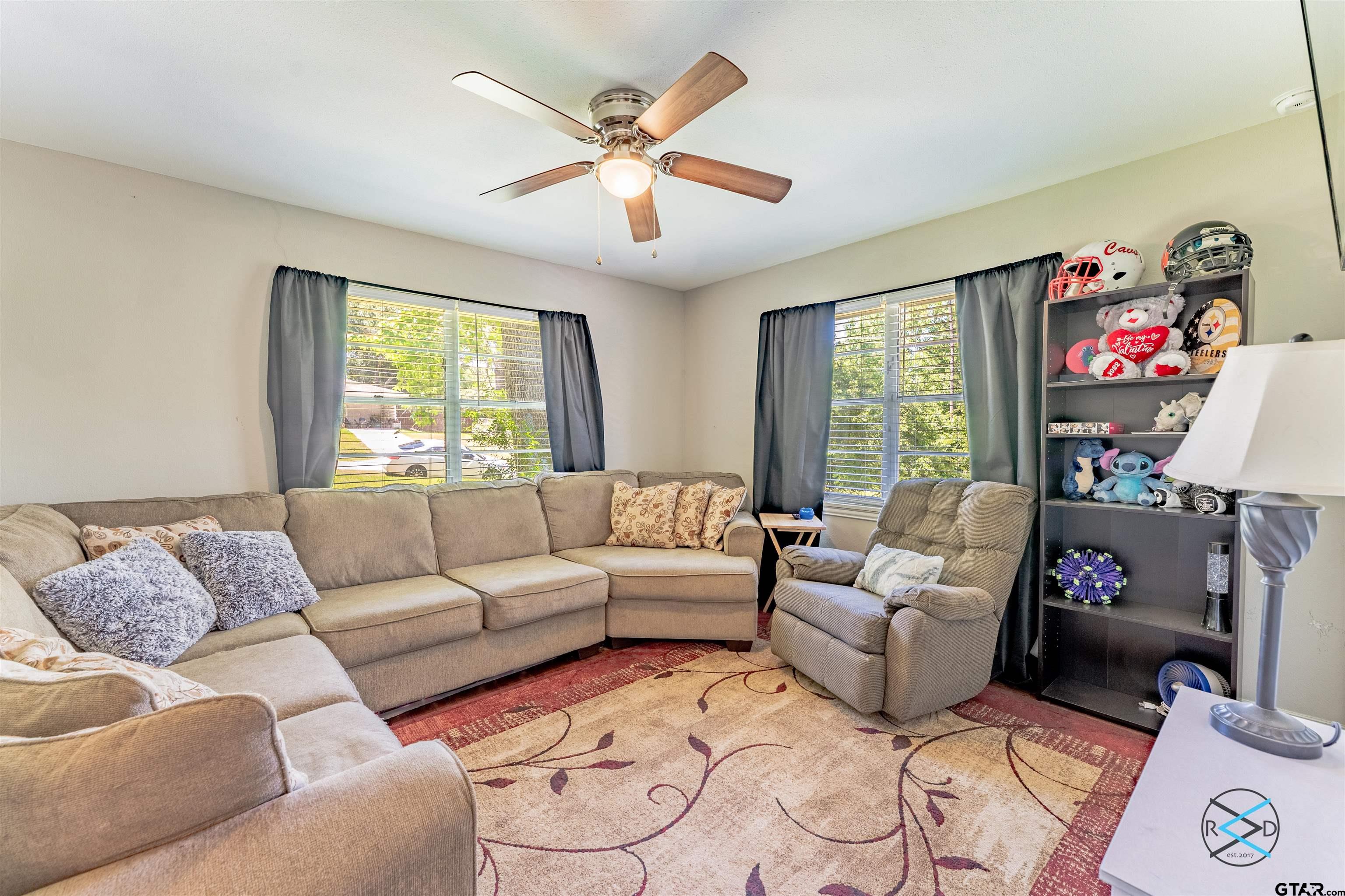 1506 Bassett Road Palestine, TX 75803 - Photo 3 of 18 a living room with furniture a flat screen tv and a large window