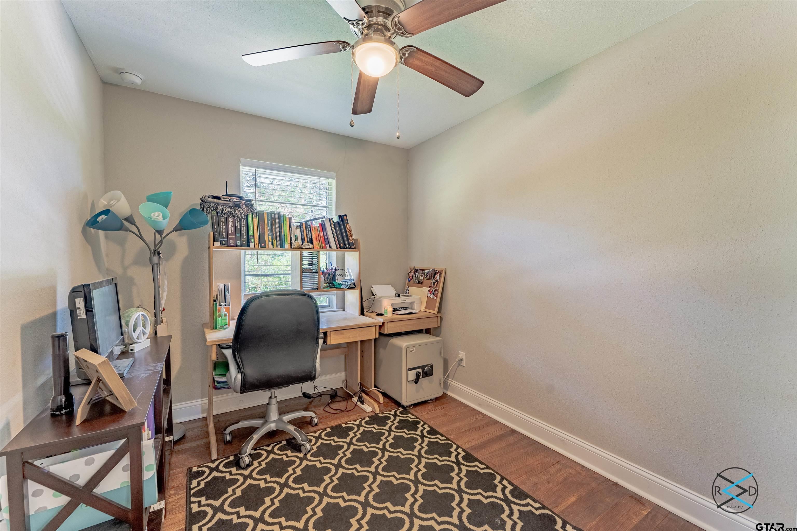 1506 Bassett Road Palestine, TX 75803 - Photo 9 of 18 a workspace with furniture and chandelier