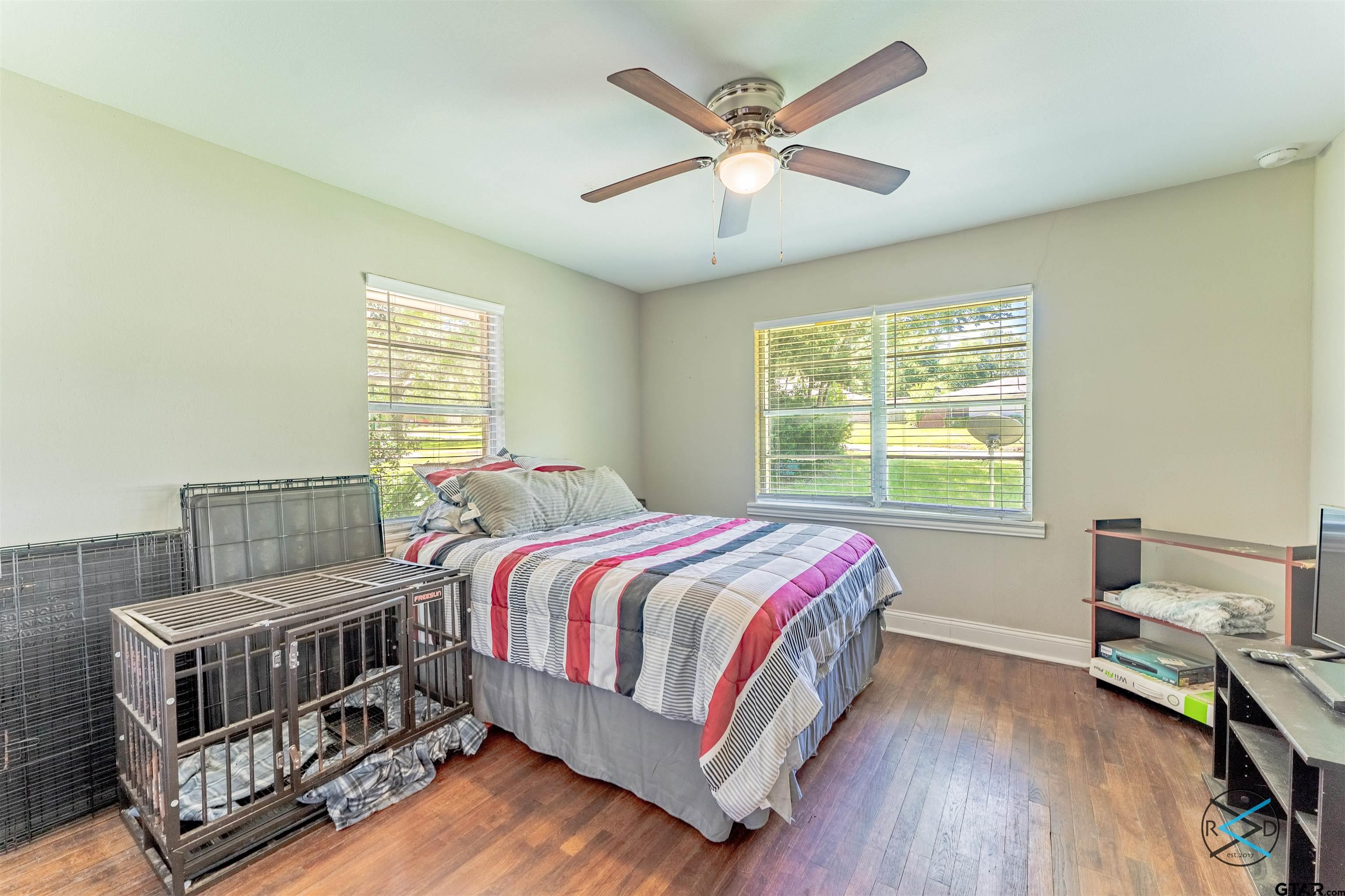 1506 Bassett Road Palestine, TX 75803 - Photo 10 of 18 a bedroom with a bed a chandelier and a window