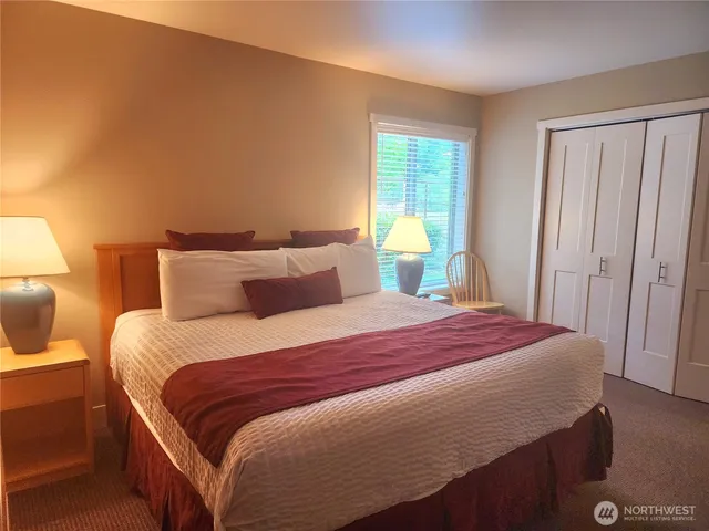 a bathroom with a granite countertop sink toilet a mirror and shower