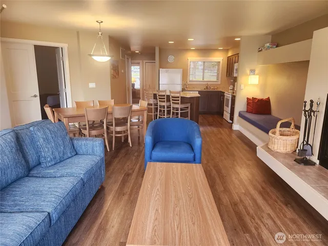 a living room with furniture a large window and a fireplace