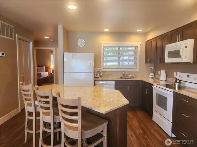 a large kitchen with a table and chairs