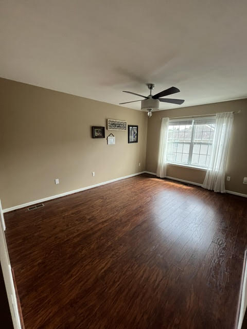 2212 Rising Hill Road Whitehall, PA 18052 - Photo 12 of 21 Rich hardwood-style flooring extends across this well-lit living area, featuring a contemporary ceiling fan for year-round comfort.