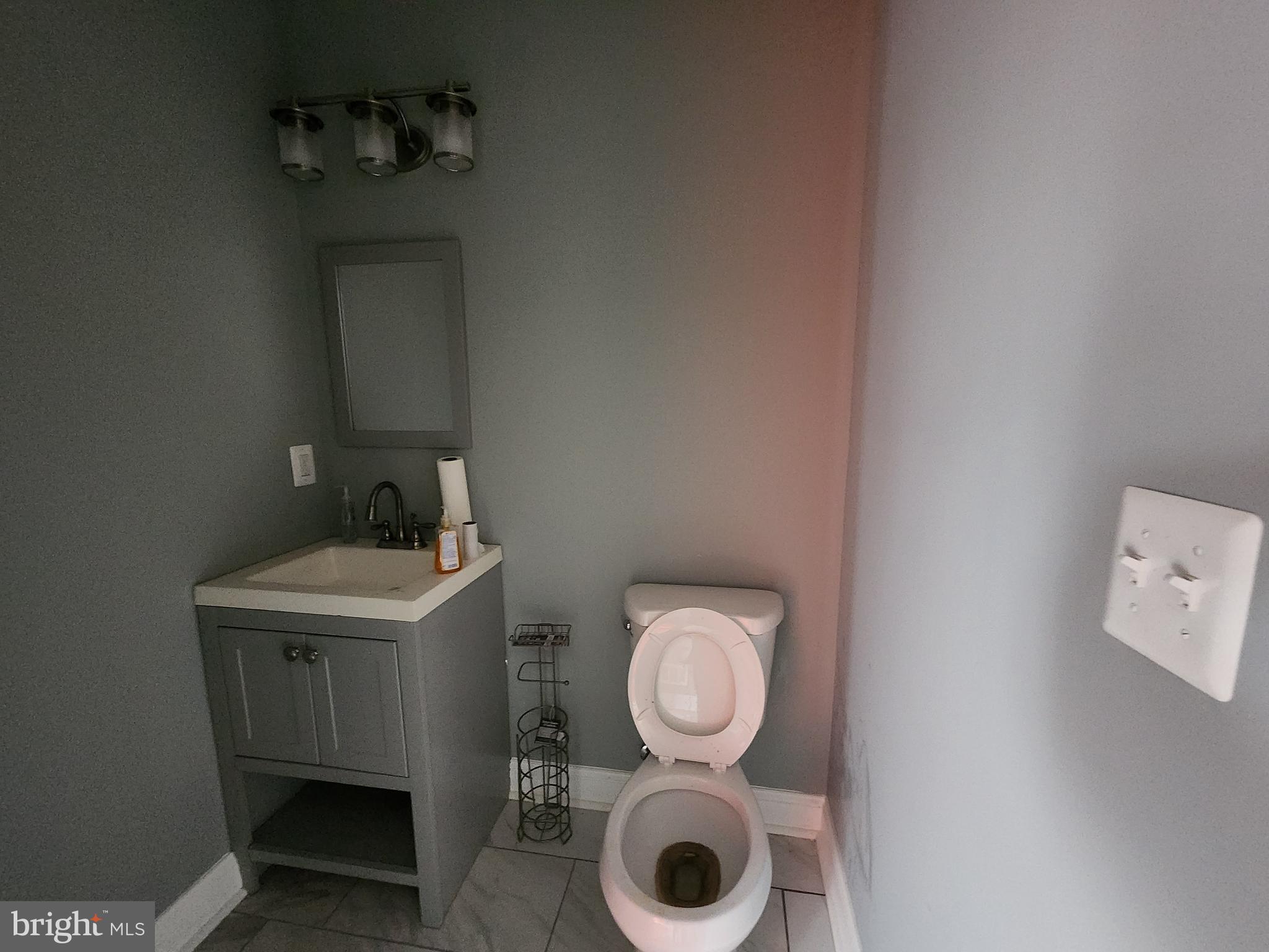 1629 Rutland Avenue Baltimore, MD 21213 - Photo 12 of 20 a bathroom with a sink and a mirror