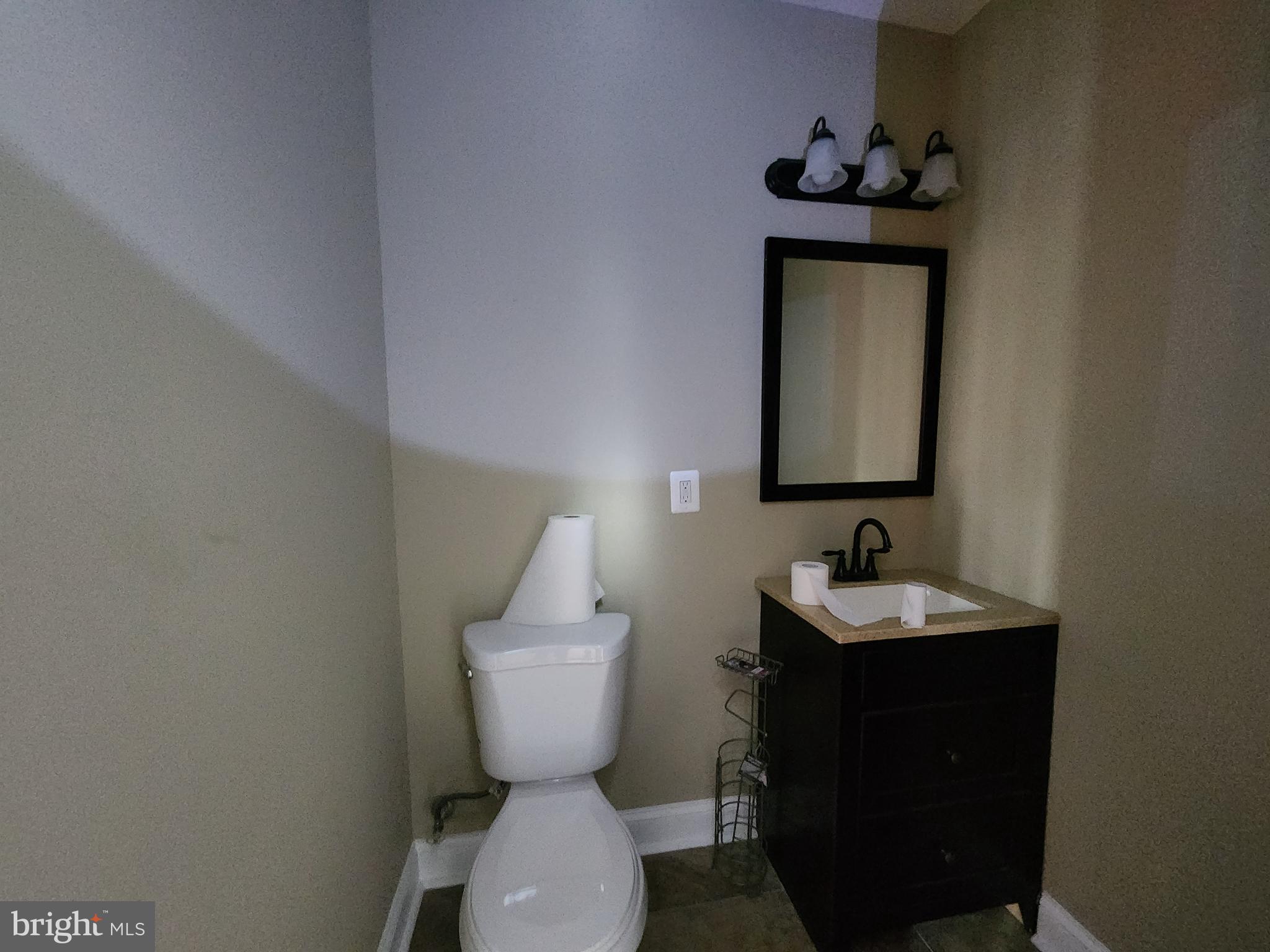 1629 Rutland Avenue Baltimore, MD 21213 - Photo 13 of 20 a bathroom with a toilet sink and mirror