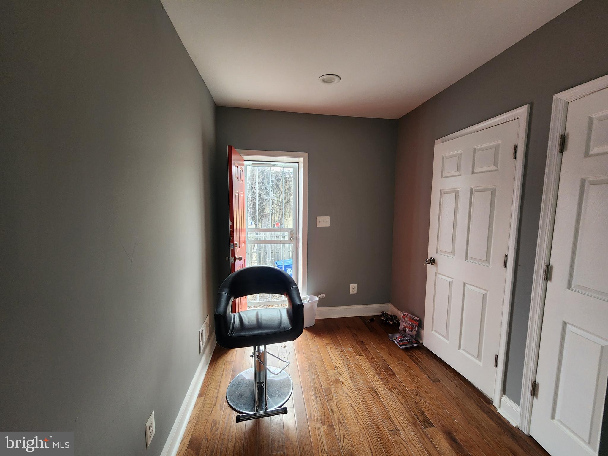 1629 Rutland Avenue Baltimore, MD 21213 - Photo 10 of 20 wooden floor in an empty room with a window