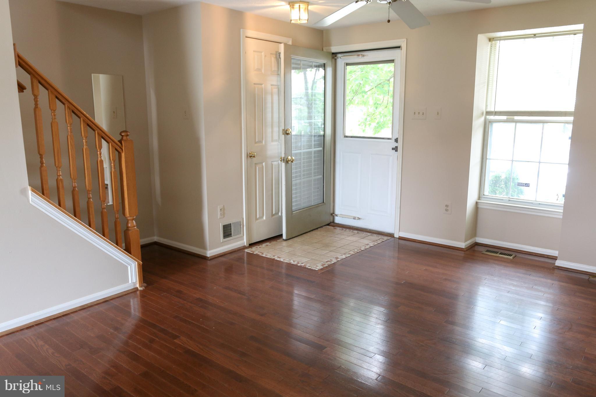 2212 Riding Crop Way Baltimore, MD 21244 - Photo 2 of 19 an empty room with wooden floor and windows