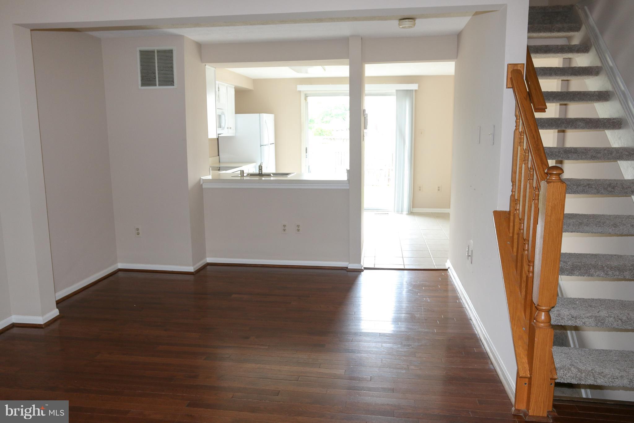 2212 Riding Crop Way Baltimore, MD 21244 - Photo 3 of 19 a view of an empty room with wooden floor and a window