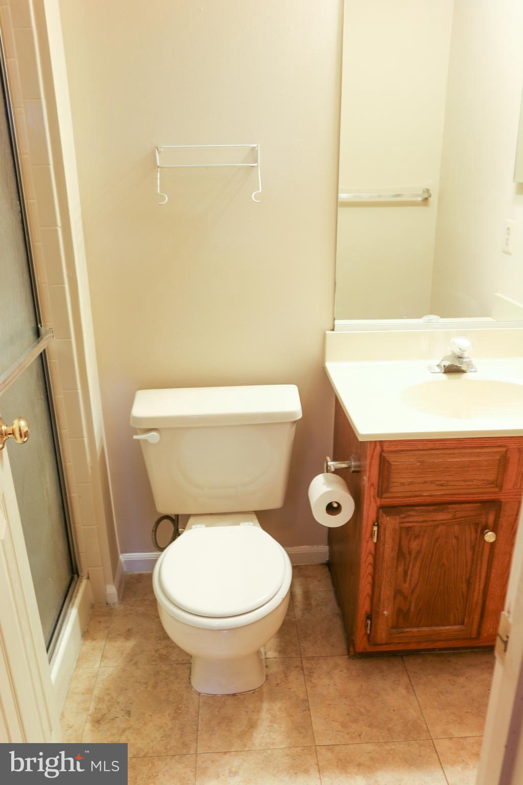 2212 Riding Crop Way Baltimore, MD 21244 - Photo 8 of 19 a white toilet sitting next to a bathroom sink