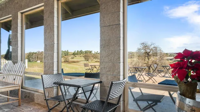 a living room with lots of furniture and kitchen view