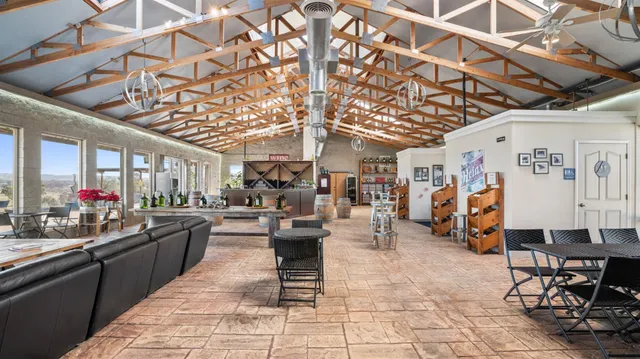 a living room with furniture and a floor to ceiling window