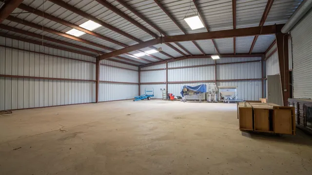 a view of a big house with big yard and a large tree