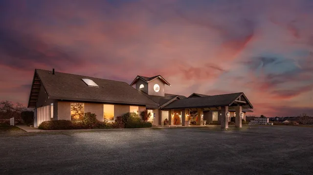 a front view of a house with a garden